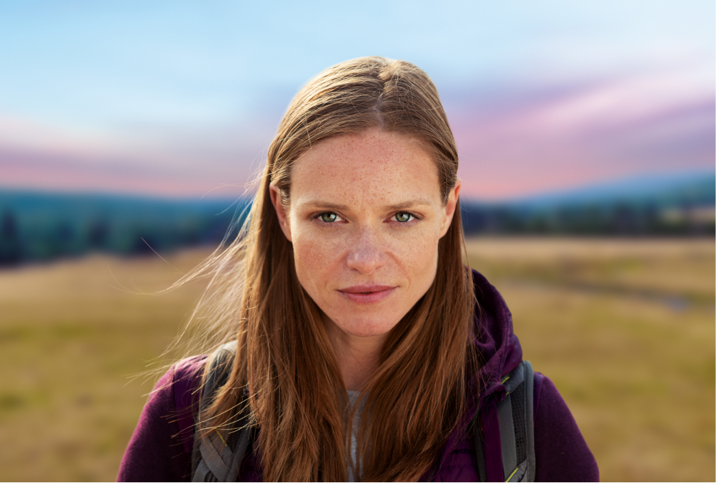 Woman in hike gear standing in the field