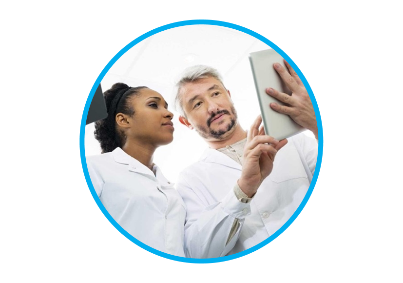 An image a man and a woman wearing a lab coat while interacting with a tablet