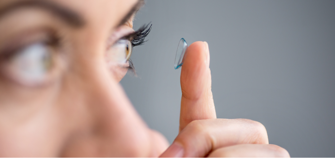 Woman applying a contact lens