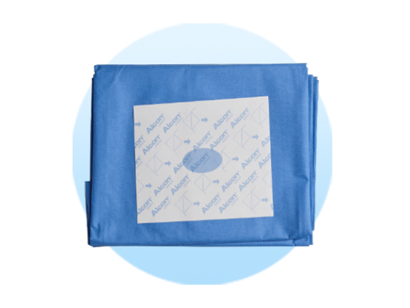 Folded surgical drapes on a pale blue circle background.