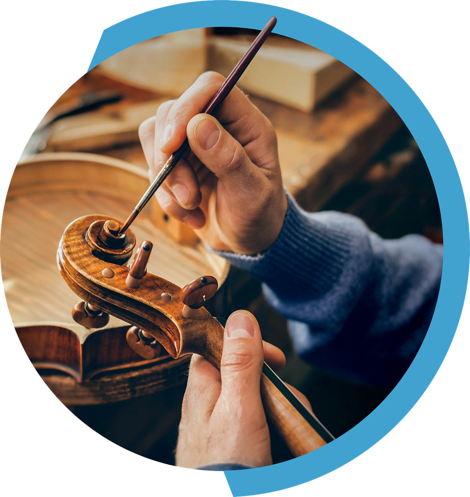 Circular image of man painting a violin with blue border